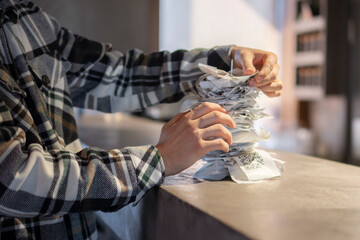 Waiter Organizing Stack of Paper Orders at Busy Restaurant Bar During Lunchtime Rush