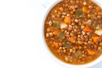 Lentil soup with vegetables in bowl isolated on white background. Top view. Copy space