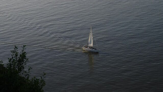 Sailboat sailing over Tagus River in Almada, Lisbon, Portugal