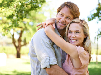 Fototapeta premium Couple, care and hug in park for romance, travel and commitment in marriage or relationship on trip. Mature people, love and bonding on outdoor date in garden, support and embrace on summer holiday