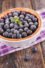 blueberry tart on wood background