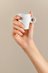 Unrecognizable woman hand with white coffee cup