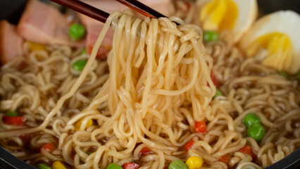 Tradition ramen noodles with eggs and bacon, close up