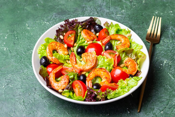 Salad with shrimps, tomatoes, olives and nuts. Healthy eating.