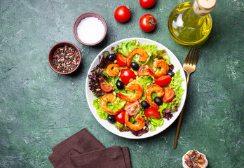Salad with shrimps, tomatoes, olives and nuts. Healthy eating.