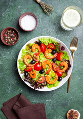 Salad with shrimps, tomatoes, olives and nuts. Healthy eating.