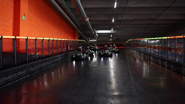 competition karting race front view of the karts advancing on the indoor circuit