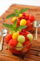 Fruit balls with red currants coulis.
