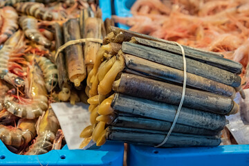 Ensis ensis or the sword razor, clams shelled or caught on the day and freshly unloaded from the boat, for sale in the fishmonger of a market in a city on the Spanish coast.