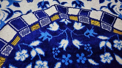 a blue and white rug with a floral design