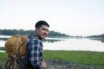 Asian tourist smiling happily Backpacker, hiking trips, outdoor activities on vacation.