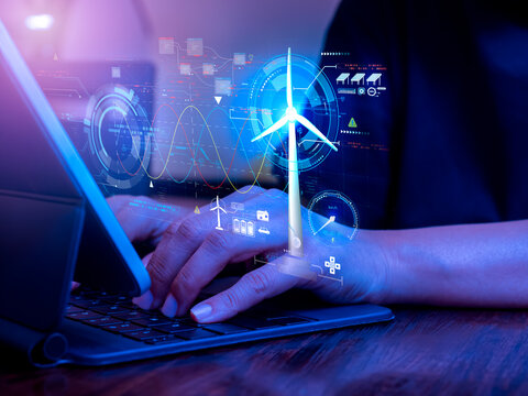 Renewable energy sustainability and innovation concept. Digital virtual screen with wind turbine power display, data system and management control, online process technology, engineer using computer.