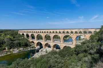 Fototapete Pont du Gard High angle view of the aqueduct bridge Pont du Gard over the Gardon river near Vers-Pont-du-Gard, France with well-preserved arched tiers, built by 1st-century Romans