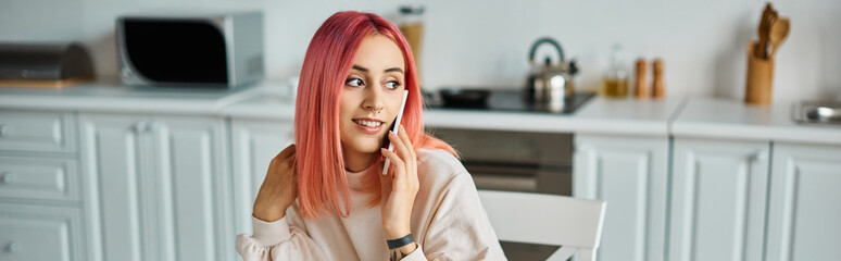 cheerful attractive woman with vibrant pink hair talking by phone and looking away, banner