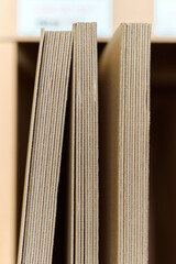 A pile of freshly made unprepared brown card board boxes fresh from manufacture. Cardboard box storage and transport solution in a cardboard box factory warehouse distribution