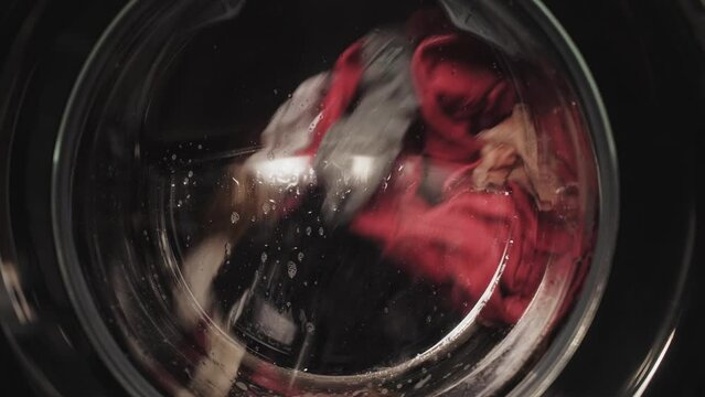 Washing machine in the process, wash clothes in the washing machine, close-up of cleaning clothes.