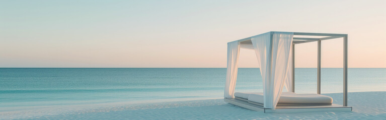 A wooden canopy bed sits on the beach, offering shade and a stunning view of the horizon where the water meets the sky