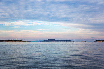 Beautiful seascape with lighthouse at the sunset on the Aegean sea