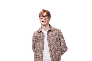 a young smiling man with red golden hair in glasses and a shirt stands alone on a white background