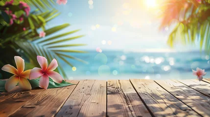 Fotobehang An empty wooden desk adorned with plumeria flowers and palm leaves sits against an ocean backdrop, illuminated by bokeh sunlight. Background for displaying summer and tropical beach products. © Bnz