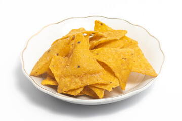 Crispy corn tortilla nachos chips in a small white plate isolated on white background clipping path