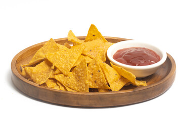 Crispy corn tortilla nachos chips with sauce in a wooden plate isolated on white background clipping path
