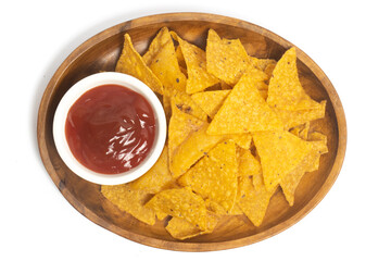 Crispy corn tortilla nachos chips with sauce in a wooden plate top view isolated on white background clipping path