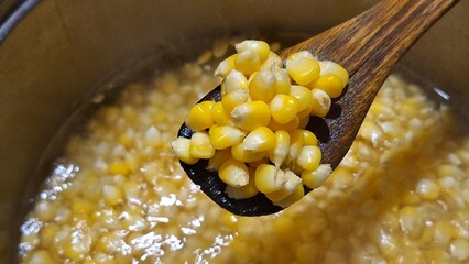 Sweet corn kernels being boiled in a pot