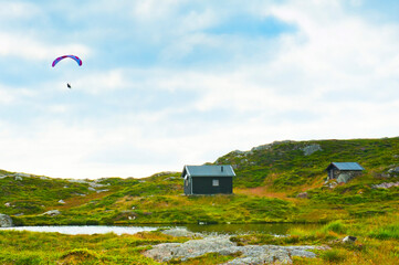Beautiful landscape with small houses and paraglider seen from the Mount Ulriken in Bergen, Norway - 748687943