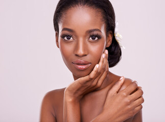 Portrait, skincare and serious with natural black woman in studio on pink background for wellness. Face, beauty and cosmetics with confident young aesthetic model at spa for dermatology treatment