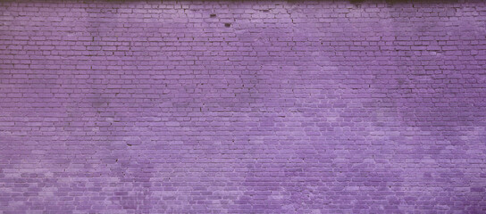 The texture of the brick wall of many rows of bricks painted in violet color.