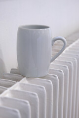 White coffee cup on a white radiator