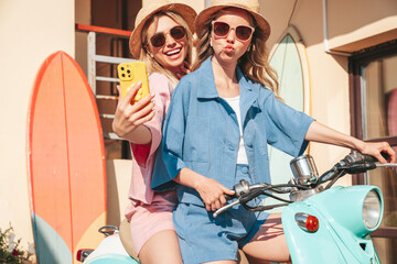 Two young beautiful smiling hipster female in trendy clothes. Carefree women driving retro...