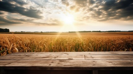 Obraz premium An old wooden table against the backdrop of a wheat field.