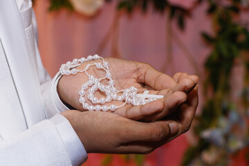 Closeup shot of a person holding rosary beads