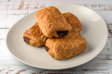 freshly baked croissants on wooden cutting board, top view