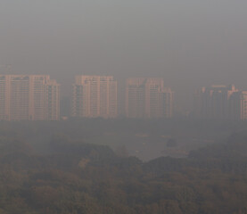 Naklejka premium Gurgaon,Haryana,India skyline on a foggy winter morning.Aerial view of Gurugram urban cityscape with modern architecture,commercial ,luxury residential apartment buildings.Delhi NCR.