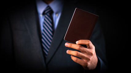 Businessman holding a passport in hand