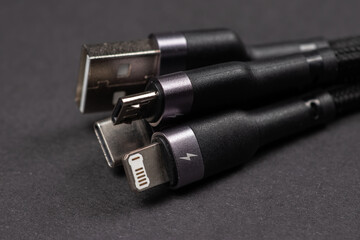 digital computer or smartphone cables. Usb type c, mini-usb, lightning connector. on dark background