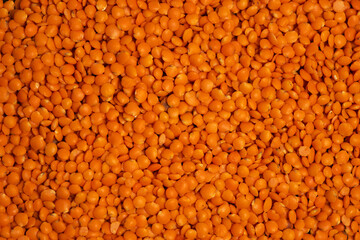 Red lentils background or texture. Closeup, top view