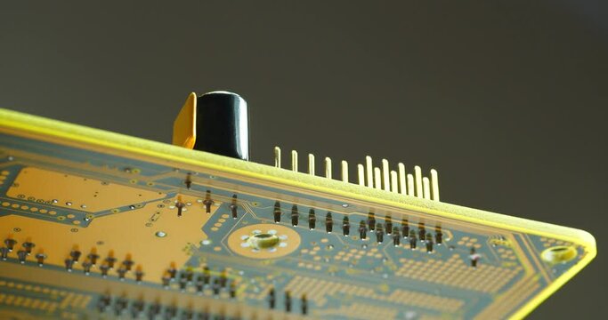 Computer microcircuit with electronic components, resistors and connection terminals. Cinema 4K 60fps zoom-out video