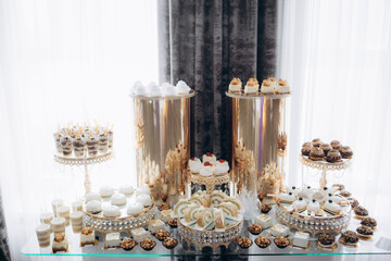 A delicious wedding. Candy bar for a banquet. Celebration concept. Fashionable desserts. Table with sweets, candies. Fruits