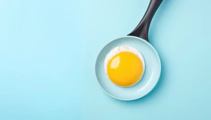 Fotobehang Frying pan with eggs on blue background © terra.incognita