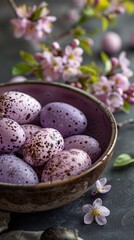 Obraz na płótnie Canvas purple speckled easter eggs adorned with spring flowers in a ceramic bowl