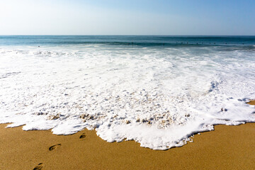 Big waves splash and climb on the beach. High quality photo