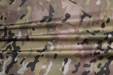 Texture of crumpled camouflage fabric as background, top view
