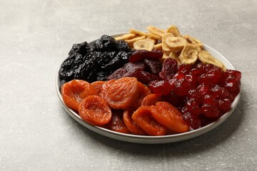 Delicious dried fruits on grey table, closeup