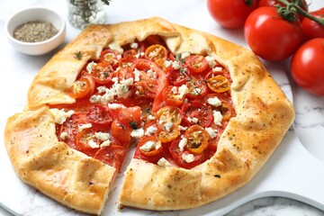 Tasty galette with tomato, thyme and cheese (Caprese galette) on white table, closeup