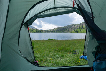 View from a tent in the Alps, near a lake. High quality photo