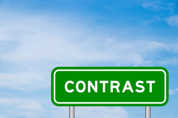 Green color transportation sign with word contrast on blue sky with white cloud background